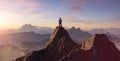 Adventurous Man Hiker Standing on top of a rocky mountain overlooking the dramatic landscape