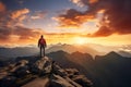 Adventurous Man Hiker Standing on top of a rocky mountain overlooking the dramatic landscape at sunset Royalty Free Stock Photo