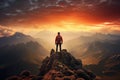 Adventurous Man Hiker Standing on top of a rocky mountain overlooking the dramatic landscape at sunset Royalty Free Stock Photo