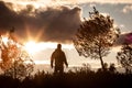 Adventurous man observing a lovely sunset in nature, alone, stan Royalty Free Stock Photo