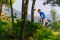 Adventurous mountain biker riding his bike fast through the woods  forest  while enjoying the green nature Royalty Free Stock Photo