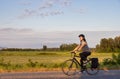 Adventurous White Cacasusian Woman riding a bicycle on a road.