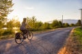 Adventurous White Cacasusian Woman riding a bicycle on a road.