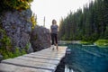 Adventurous White Caucasin Adult Woman Hiking on a trail in Canadian Nature