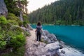 Adventurous White Caucasin Adult Woman Hiking on a trail in Canadian Nature