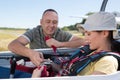 adventurous woman being strapped into sailplane Royalty Free Stock Photo