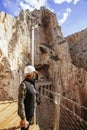 Adventurous woman with helmet appreciating a cliff on her holidays