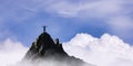 Adventurous Woman Hiker Standing on top of a rocky mountain overlooking the dramatic landscape.