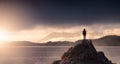 Adventurous Woman Hiking on the Rocky Coast with Mountains and Dramatic Sunset Sky. Royalty Free Stock Photo