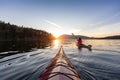 Adventurous Woman on Sea Kayak paddling in the Pacific Ocean.