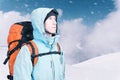 Adventurous young man with backpack standing on mountain top view and looking out. Mountaineering, extreme sport. Royalty Free Stock Photo