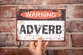 Adverb Warning Sign Held Against Brick Wall for Grammar Concept Royalty Free Stock Photo
