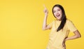 Adverisement presenting concept. Cheerful young woman use finger pointing to product or empty copy space while standing over Royalty Free Stock Photo