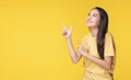 Adverisement presenting concept. Cheerful young woman use finger pointing to product or empty copy space while standing over Royalty Free Stock Photo