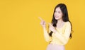 Adverisement presenting concept. Cheerful young woman use finger pointing to product or empty copy space while standing over Royalty Free Stock Photo