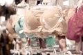 Advertise, Sale, Fashion concept - Close up of woman`s hand choosing underwear on hangers in the supermarket