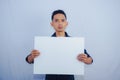 Advertisement Concept. Portrait of asian man holding empty blank board isolated on white studio background. Royalty Free Stock Photo