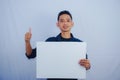 Advertisement Concept. Portrait of asian man holding empty blank board isolated on white studio background. Royalty Free Stock Photo