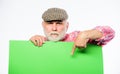 Advertisement shop. Senior bearded man peek out of banner place announcement. Pensioner grandfather in vintage hat hold Royalty Free Stock Photo