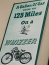 Sign. `a gallon of gas takes you 125 miles on a whizzer`