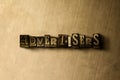 ADVERTISERS - close-up of grungy vintage typeset word on metal backdrop Royalty Free Stock Photo