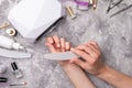 Advertising, advertising background for nails, beauty salons, work at home with nails. Girl sawing a nail file against the Royalty Free Stock Photo