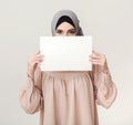 Islamic woman with blank board on white