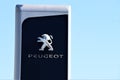 Advertising banner of `Peugeot Motors` at the entrance to a car shop. Blue sky in the background.