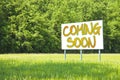 Advertising billboard with written `Coming Soon` on it