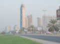 The advertising boards display various travel destination offers for the holiday season; while the humid weather compels people to