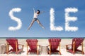 Advertising sale cloud and girl jump over beach chairs Royalty Free Stock Photo