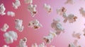 Advertising shot of flying peaces of popcorn in the air, close up shot on neutral pink background