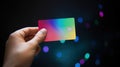 Advertising shot. Hand holding colored credit card on blured illuminated background