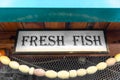 Advertising sign fresh fish fishing net entrance fish market restaurant Royalty Free Stock Photo