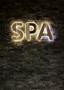 Advertising sign spa area on a black brick wall Royalty Free Stock Photo