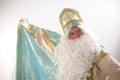 long cloak Saint Nicholas lifted with one hand and wrapped like a superman Sinterklaas portrait USA on a white Royalty Free Stock Photo