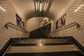 Advertising and stairs in passageway linking stations of the Paris Subway.