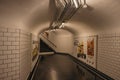 Advertising and stairs in passageway linking stations of the Paris Subway.