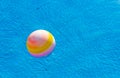 Advertising summer time vacation concept wallpaper pattern photography of ball floating on swimming pool water surface background Royalty Free Stock Photo