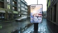 advertising travel billboard on city street at evening