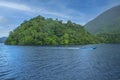 Advertising, Travel, Vacation and Holiday Concept - A boat passing by in front of the small remote island