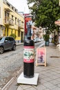 Advertising wine tasting in the form of a large bottle with a corkscrew is on the street on a rainy day of Batumi city - the