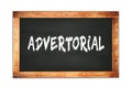 ADVERTORIAL text written on wooden frame school blackboard