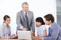 Advising his young team - Business Management. A business manager leading a strategy meeting at the office. Royalty Free Stock Photo