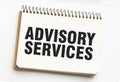 ADVISORY SERVICES on notepad with white background