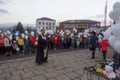 Orthodox priest and people with white balloons on the day of mourning for those killed in the fire in the city of Kemerovo