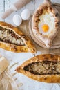 Adzharian khachapuri with egg and traditional turkish pide with meat