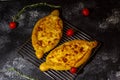Adzharian khachapuri on a grill on a crispy surface with tomatoes Royalty Free Stock Photo