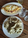 Adzharian khachapuri and khinkali on the table. Royalty Free Stock Photo