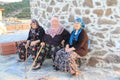 Aegean area - old villager women sitting at the wind mill